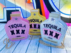 3 sparkly tequila bottle shaped purses in pink, gold, and silver