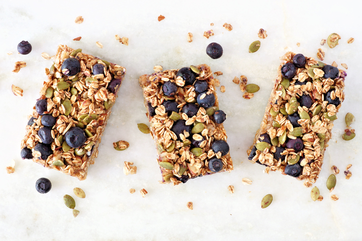 Superfood breakfast bars, above view on marble background